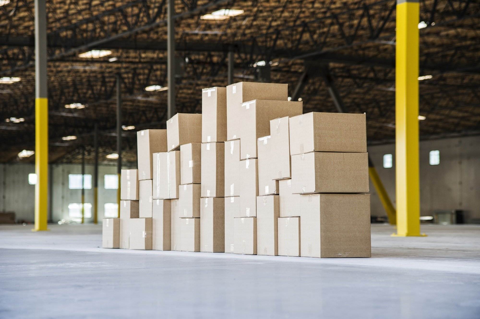Group Of Cardboard Boxes In A Brand New Large Warehouse Space