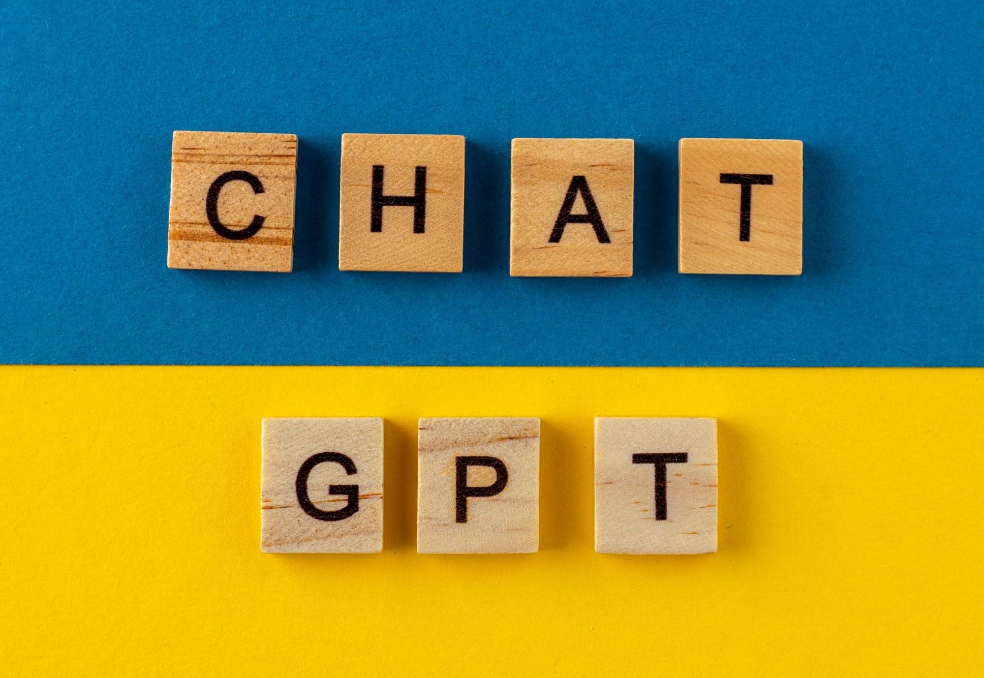 ChatGPT background Words in wooden letters Chat with AI or Artificial Intelligence by OpenAI
