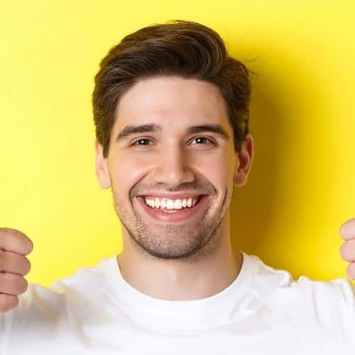 close up of handsome young man showing thumbs up utc min jpg